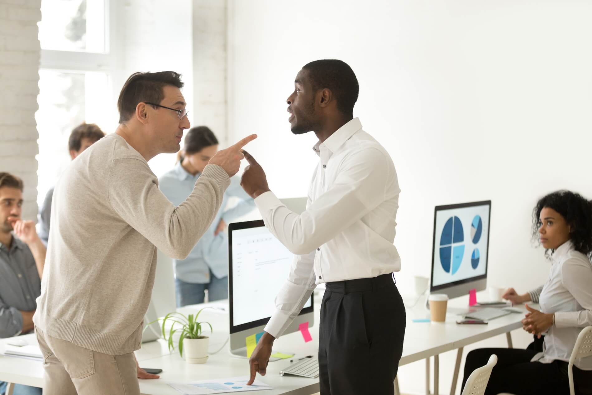 multiracial african caucasian colleagues disputing having