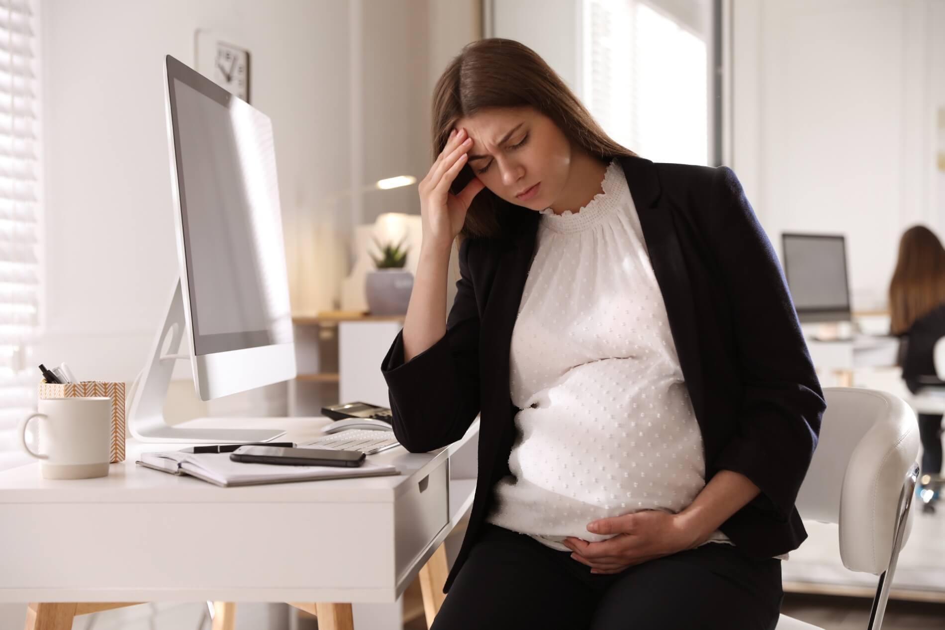 tired pregnant woman working home maternity